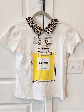 White Graphic Tee with Yellow Perfume Bottle Print and Leopard Collar